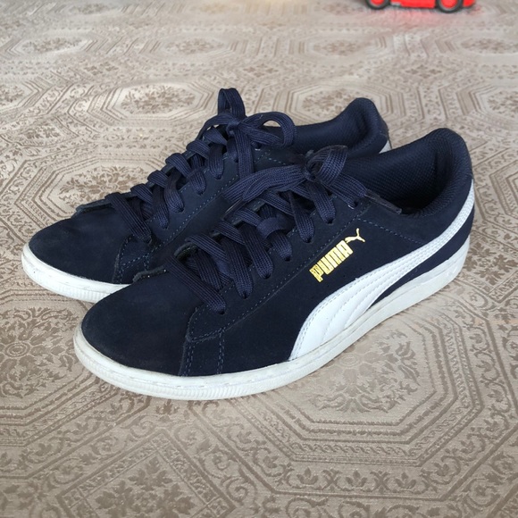Navy blue and white Puma sneakers